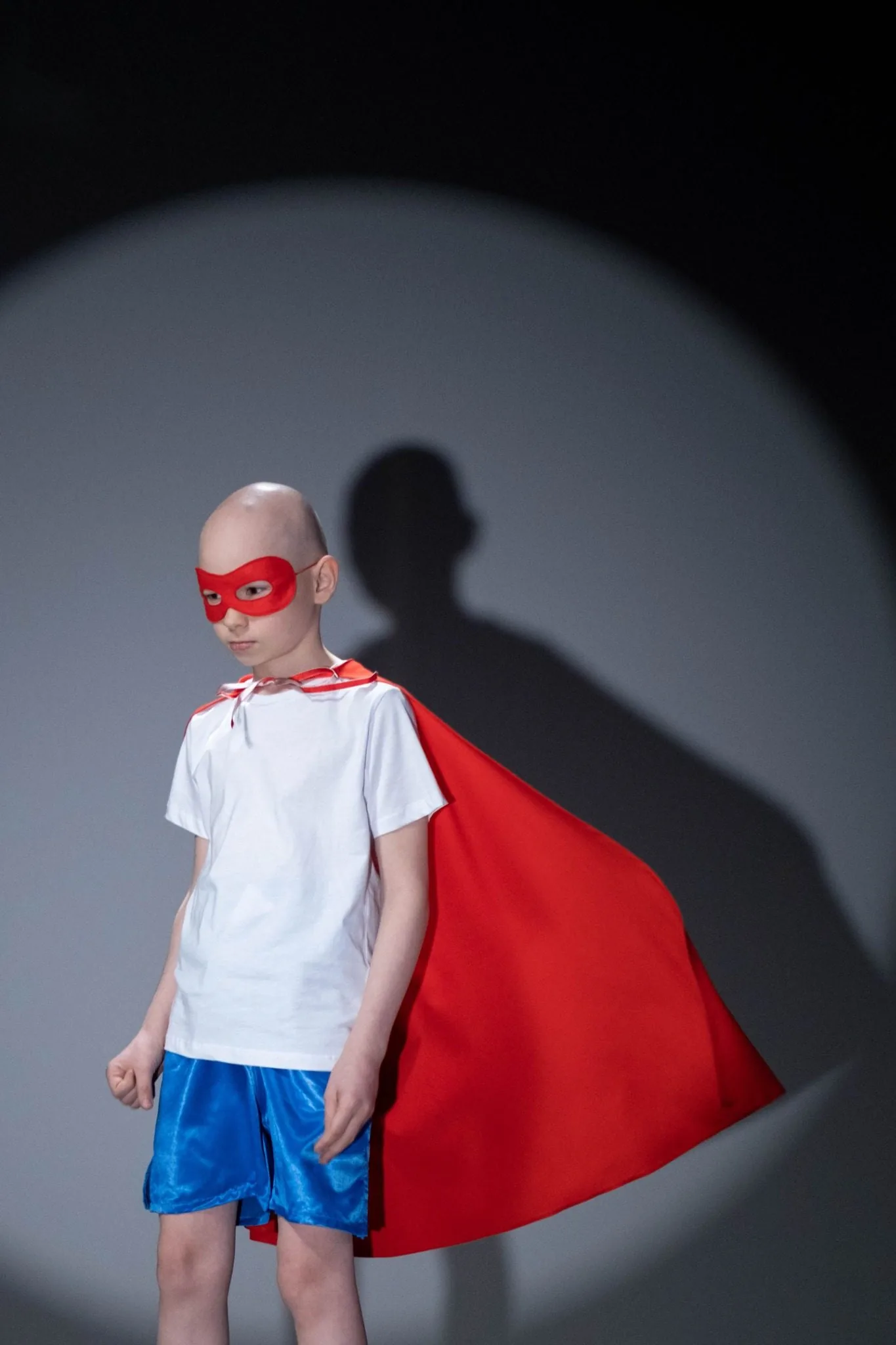 Before: child in a homemade superhero costume photographed against a plain studio backdrop